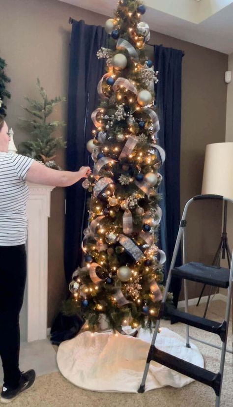 If you’ve ever considered a skinny tree, but were hesitant because you weren’t sure how to decorate it, today’s your lucky day!I created the most detailed recap of how I decorated our skinny tree in this post and the best part?It was so easy!! Let's get to it! Pre-Decorating TipsThere are a couple of things to consider before you dive into decorating your tree.First things first, you want to pick a Christmas color scheme.This will help you create a cohesive look, even if it’s just fo… Slim Xmas Tree Decorating Ideas, Pencil Trees Decorating Ideas, Christmas Tree With Ribbon, Tree With Ribbon, Black Christmas Decorations, Christmas Tree Decorating Tips, Christmas Checklist, Christmas Colour Schemes, Slim Christmas Tree