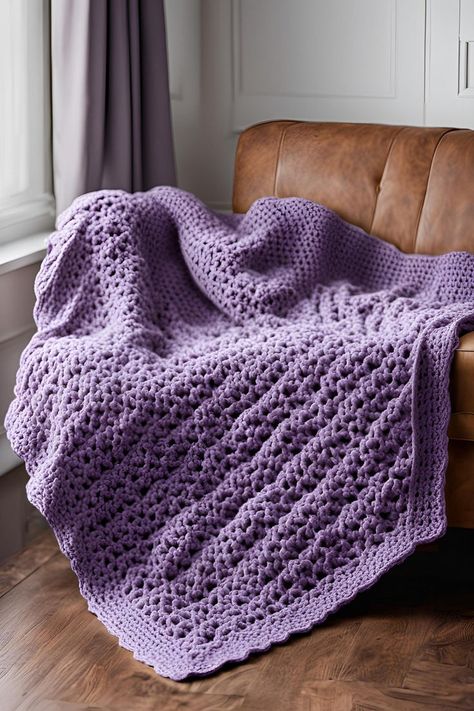 A lavender crocheted blanket draped over a leather chair, with a potted plant and framed artwork visible in the background. Easy Crochet Blanket Patterns, Velvet Throw Blanket, Cables Blanket, Tassel Blankets, Chunky Crochet Blanket, Crochet Blanket Pattern Easy, Easy Crochet Blanket, Waffle Stitch, Shell Stitch