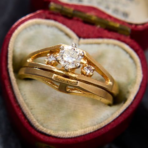 This bright diamond wedding set is crafted of 14k yellow gold and displays high polished and brushed gold. The engagement ring features one round brilliant cut diamond set into four-prong setting and two single cut diamond accents. The wedding set is currently a size 6. Antique Engagement Rings Sapphire, Estate Jewelry Rings, Wedding Ring Diamond Band, Diamond Wedding Sets, Antique Engagement Rings, European Cut Diamonds, Wedding Set, Diamond Set, Sapphire Engagement