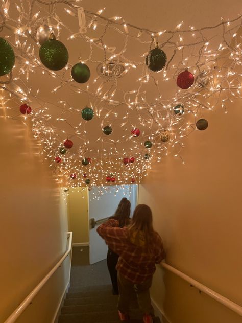 Christmas Light On Ceiling, Christmas Light Ceiling, Interior Christmas Light Ideas, Christmas Decor For Hallway, Christmas Ceiling Lights, Ornaments On Ceiling, Stairwell Christmas Decor, Ornaments Hanging From Ceiling, Christmas Stairwell