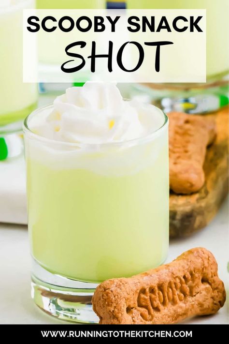 This Scooby Snack Shot is the perfect nostalgic party drink! Made with Midori melon liqueur, coconut rum, pineapple juice, and cream, this vibrant Scooby Snack drink will bring back memories of Saturday morning cartoons. Top the Scooby shot recipe with whipped cream and a Scooby Snack graham cracker for a fun, playful touch. Easy to make and perfect for any gathering, this Scooby Snack Shot will have everyone talking and reminiscing about their favorite childhood moments! Scooby Snack Shot Recipes, Scooby Snack Drink, Scooby Snack Shot, Midori Melon, Spooky Halloween Food, Graham Cracker Cookies, Melon Liqueur, Scooby Snacks, Easy Drink Recipes