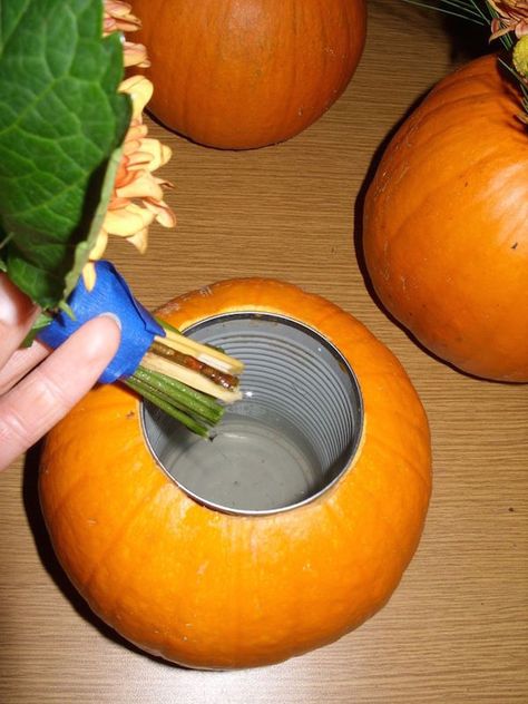 Carve out the center of a pumpkin, insert a soup can, and place flowers inside for an expensive looking (yet cheap) DIY fall centerpiece. Pumpkin Vase, Vase Diy, Pumpkin Flower, Dalian, בר מצווה, Pumpkin Decor, Fall Party, Deco Floral, Fall Holidays