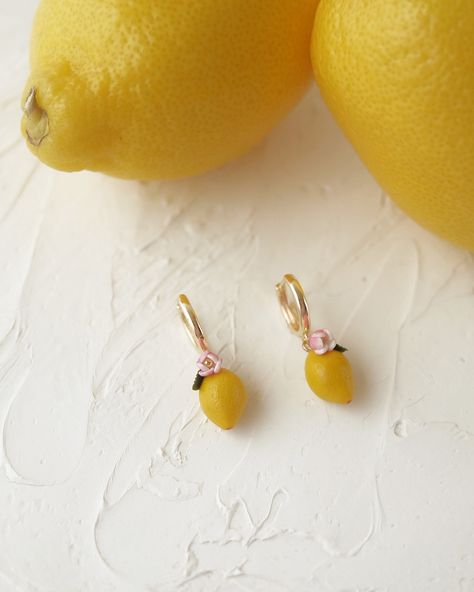 Obsessed with these new lemon drop earrings! 🍋 They’re like tiny pieces of summer for your ears. Handmade with polymer clay, so they’re as real as it gets (without the juice, don’t worry). Perfect for adding a pop of color to any outfit. ☀️ #clayearrings #polymerclayindia #handmadejewelry #polymerclay #handmadewithlove #fruitearrings #lemon (lemon earrings, polymer clay, handmade jewelry, summer accessories, floral hoops, unique earrings, trendy jewelry, fashion jewelry, statement earr... Lemon Earrings, Quirky Jewelry, Earrings Polymer, Fruit Earrings, Jewelry Summer, Earrings Trendy, Floral Hoops, Earrings Polymer Clay, Jewelry Statement