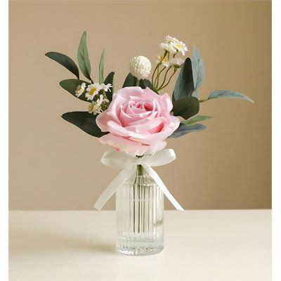 The petals are arranged in layers, creating a rich and natural look. Primrue Flower Colour: Pink | Primrue Rose Floral Arrangements in Vase Pink/indigo 10.24 x 5.12 x 5.12 in | C110933561_470758456 | Wayfair Canada Pink And White Centerpieces Simple, Simple Small Flower Centerpieces, Pale Pink Centerpieces, Pink Rose Arrangements Vase, Pink And White Bud Vases, Small Rose Arrangements, Pink And Sage Decor, Minimalist Wedding Centerpieces Simple, Small Table Centerpiece Wedding