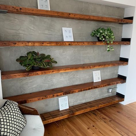 Good Wood Nashville on Instagram: “Stunning shelves -nice blend of concrete walls, reclaimed heart pine floors & steel supports.  Interesting note: these beams came out of a…” Shelves On Concrete Wall, Wood Beam Shelf, Concrete Farmhouse, Hang Shelves, Reclaimed Wood Bar, Tub Room, Basement Bars, Beams Living Room, Concrete Block Walls