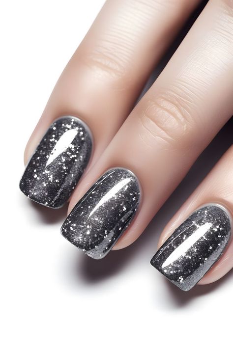 steel gray nails, glittery nails, sparkly nail ideas, nail art inspo, gray nail designs, New Year's nails, nail trends, nail inspiration, holiday beauty, nail goals, nail fashion, festive nails, winter nail inspo, seasonal nails, nail ideas, nail creativity, party nails, elegant nails, glamorous nails, trendy nail designs, chic nails, beautiful nails, stylish nails, nail magic, fabulous nails Dark Grey Christmas Nails, Dark Grey Sparkle Nails, Dark Grey Nails With Design, Glitz And Glam Nails, Black Holiday Nails Christmas, Dark Silver Nails, Dark Grey Nail Ideas, Gray Sparkle Nails, Festive Nails Winter