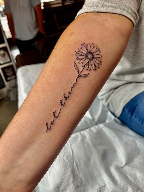 Grace Wrist Tattoos For Women, Let Them Sunflower Tattoo, Let Them With Flowers Tattoo, 1 Word Tattoos For Women, Sunflower Tattoo With Name In Stem, Tattoos For Side Of Arm, You Saved Me Tattoo, Let Them Tatoos, Let Them Flower Tattoo