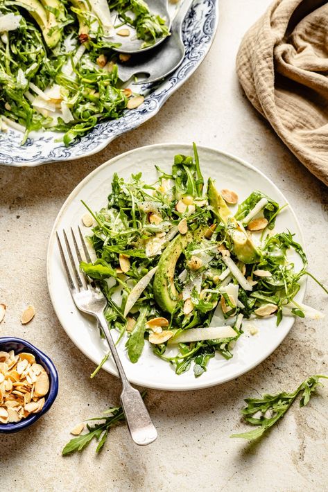 Beautiful and simple arugula pear salad with savory asiago cheese, almonds, creamy avocado, and a light white balsamic vinaigrette. This fresh arugula salad has delicious bites of sweet, salty, zippy flavor and tons of wonderful textures for an easy holiday side dish or weekday lunch! Enjoy as is or pair with your favorite protein for a complete meal. Simple Arugula Salad Recipes, Arugula Pear Salad, Simple Arugula Salad, Easy Holiday Side Dishes, White Balsamic Vinaigrette, Arugula Salad Recipes, White Balsamic, Holiday Side Dish, Paleo Salads