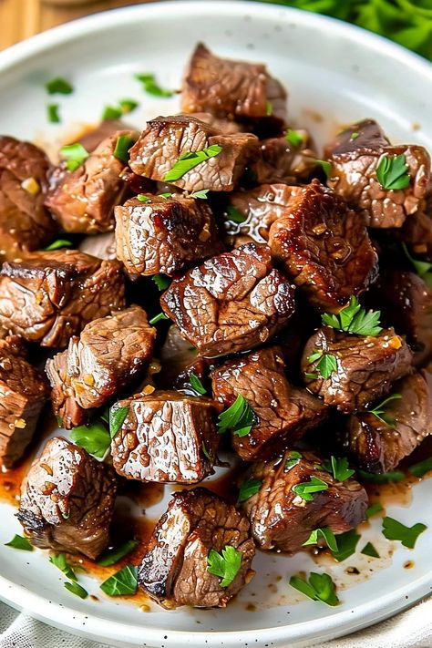 These garlic butter steak bites are quick, easy, and fabulous! Tender sirloin is cooked to perfection then drizzled with freshly made garlic butter. Steak Bites Charcuterie, Steak Stovetop Recipes, Dutch Oven Steak Tips, Beef Stew Meat Steak Bites, Mediterranean Steak Bites, Ribeye Strip Recipes, Beef New York Strip Steak, Steak Bites Stovetop, Skillet Beef Tips