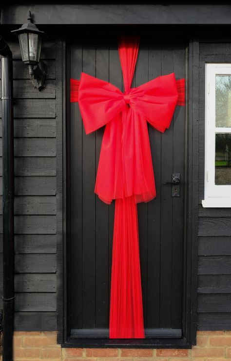 Christmas Front Door Ribbon, Ribbon On Windows For Christmas, Christmas Ribbon On Door, Red Christmas Door Decoration, Christmas Wrapped Door, Door Wrapping Christmas, Christmas Door Wrap, Front Door Wrapped Like Present, Wrap Door Like Present