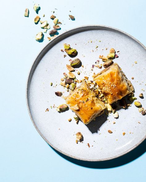 mezze dishes with sunny, harsh lighting and minimal styling. food photo with blue backdrop Baklava Photography Styling, Cold Baklava, Baklava Photography, Harsh Lighting, Christmas Content, Coffee Shop Photography, Blue Backdrop, Blue Food, Blue Backdrops