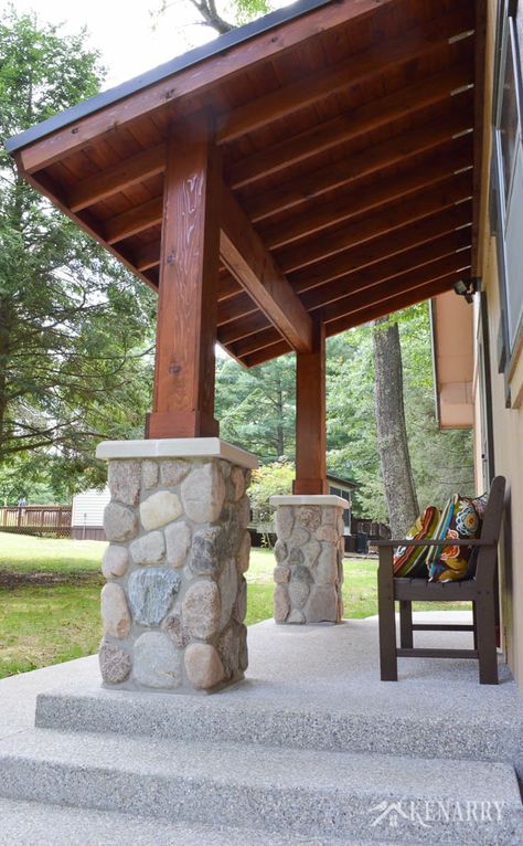 Cedar wood ceiling and river rock pillars add beautiful craftsman style to an A-frame cottage home | outdoor patio | mission style bench | home idea | exposed aggregate concrete Cedar Wood Ceiling, Craftsman Style Front Porch, Style Front Porch, Diy Concrete Patio, Exposed Aggregate Concrete, Aggregate Concrete, Exposed Aggregate, Porch Addition, Building A Porch