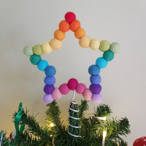 Featuring a newly updated frame and coil for Christmas 2023! Rainbow Felt Ball Star  Christmas Tree Topper ⭐Description This colourful star is handmade at my table in sunny Yorkshire, from 2cm felt balls threaded onto a wire frame so the star looks the same from the front or back. The wire spiral enables this star to be placed on top of a christmas tree. The star comes wrapped in tissue paper and sealed with a button sticker. Perfect to send as a small gift or to treat yourself.  As each tree is different, some adjustments of the wire coil may be needed to fit your star to your tree.  Custom orders are accepted so if you would like a star in a different colour, then please select 'custom colours' and add your colours into the order notes. Please select the colours from the photo in the des Christmas Tree Topper Colorful, Colourful Christmas Aesthetic, Colourful Christmas Decor, Colorful Christmas Diy, Felt Trees Diy, Diy Colorful Christmas Decor, Rainbow Christmas Decor, Whimsical Christmas Decor Ideas, Christmas Tree Topper Craft