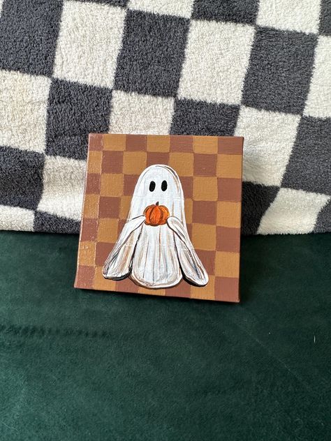 Enjoy this adorable tan and brown checkered background with a ghost holding a pumpkin Ghost Painting!  You get: 4inx4in hand painted ghost with pumpkin and checkered background - original art by me with acrylic paint and so much love, sealed with gloss varnish Easy Paint Ideas On Canvas For Beginners, Cute Fall Ghost Painting, Mini Fall Canvas Paintings, Painting Ghosts On Canvas, Easy Paintings For Halloween, Ghost Holding Pumpkin Painting, Ghost Painting On Wood, Gouache Pumpkin Painting, Ghost Painting Ideas Easy Simple