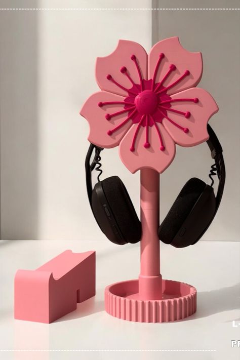 Transform your desk into a charming oasis with our Sakura-Inspired Headphone Stand. This adorable 3D-printed stand provides a secure place for your headphones while adding a touch of cuteness and whimsy to your workspace. Perfect for anyone looking to personalize their desk with functional and stylish accessories. Cozy Desk Setup, Controller Holder, Controller Stand, Cozy Desk, Headphone Stand, Headphone Stands, Ceramic Ideas, Gaming Desk, Desk Organizer