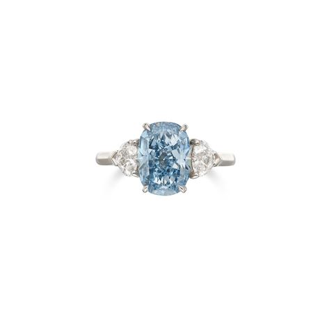 An Exquisite Fancy Vivid Blue Diamond and Diamond Ring Centering a cushion-cut Fancy Vivid Blue diamond weighing 3.01 carats, flanked by two heart-shaped diamonds weighing 0.41 carat each, size 6. Condition Report Catalogue note Accompanied by three GIA reports: no. 5201974368 dated July 22, 2020 stating that the center diamond is Fancy Vivid Blue, Natural color, VVS1 clarity. Together with a letter from the GIA stating that the diamond has been determined to be Type IIb. No. 2394294880 dated Colored Diamond Jewelry, Blue Diamond Ring, Solitaire Rings, Heart Shaped Diamond, Two Hearts, Blue Rings, Blue Diamond, Ring Ring, Cushion Cut