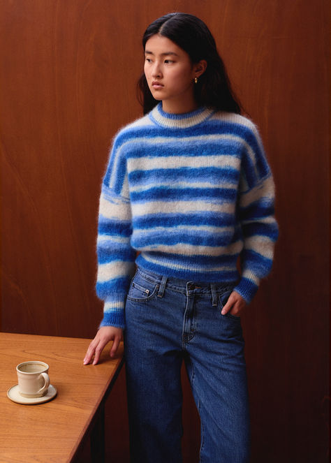 Our iconic Jane model in mohair is reimagined with unique irregular stripes for a modern touch. The Mary sweater, designed to elegantly fall over the hips, featuring a voluminous body and ribbed cuffs for a subtle blouson effect. Designed in Paris and crafted in Italy, it is made from certified RMS and Mulesing free yarn, composed of 82% Superkid Mohair, 16% recycled Polyamide, and 2% Elastane. Each sweater is one-of-a-kind, dyed before knitting, so the stripes may vary from piece to piece. Blue Mary, Fw 2024, Pull Mohair, Human Bean, Striped Knitted Sweater, Free Yarn, Fall Over, Photographs Of People, Maybe One Day