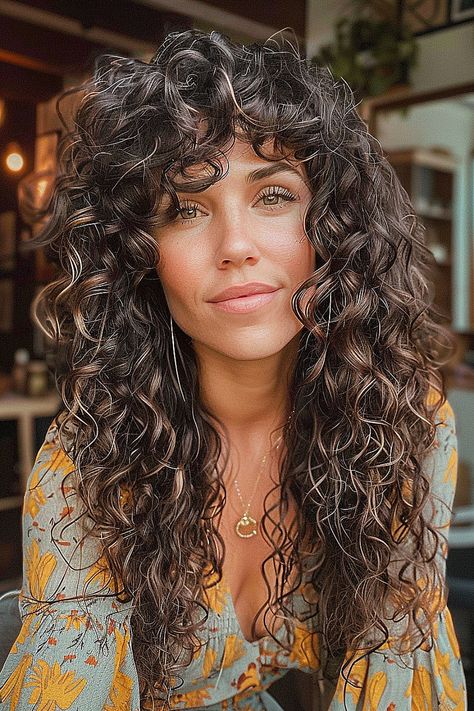 Long boho shag hairstyle with voluminous natural curls and a layered cut Curly Shag No Bangs, Medium Length Curly Shag, Curly Shag With Curtain Bangs, Curly Shag Haircut With Bangs, Shag Curly Haircut, Long Curly Shag With Bangs, Shag Cut Curly Hair, Long Curly Wolf Cut, Natural Curly Haircuts