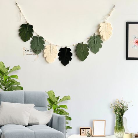 Enhance your space with a touch of organic allure using our Green Leaves Macrame Garland! An excellent option for Nursery Decor, Kid Room Decor, or Farmhouse Decor, this Macrame Wall Hanging seamlessly complements Boho Home Decor, making it a distinctive Christmas Gift. It's an ideal addition to Safari Nursery Decor or a Jungle Theme Nursery! This Boho Bunting serves as a perfect yet beautifully unique gift for your loved ones, such as friends or family. The Feather Garlands are meticulously cra Macrame Leaves Wall Hanging, Boho Bunting, Leaves Macrame, Macrame Leaves, Feather Garland, Jungle Theme Nursery, Macrame Garland, Safari Nursery Decor, Theme Nursery