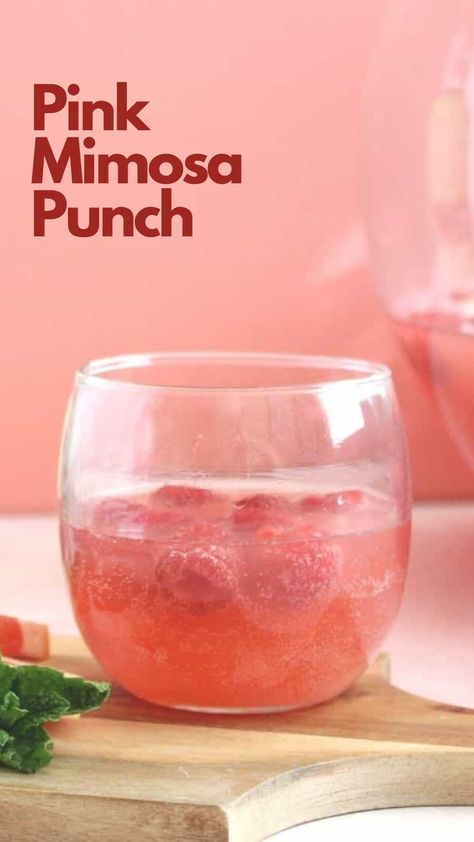 The Pink Mimosa Punch is a refreshing and fruity cocktail that is perfect for the spring season. It is made with a blend of pink lemonade, orange juice, and champagne, creating a delicious and bubbly drink that is perfect for sipping on a warm day. #PinkMimosaPunch Pink Champagne Punch Recipes, Mimosa Punch For A Crowd, Cotton Candy Mimosa, Pink Mimosa Recipe, Pink Champagne Punch, Mimosa Pitcher, Spring Punch Recipes, Pink Lemonade Punch, Spring Punch