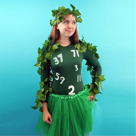 A woman dressed in green wearing leaves and a shirt with prime numbers on it. Amazon Prime Halloween Costume, Tee Shirt Halloween Costumes, Sheet Costumes Funny, Amazon Prime Costume, Lets Make A Deal Costumes Diy, Cricut Halloween Costumes, Halloween Pun Costumes Diy, Science Teacher Halloween Costumes, Easy Punny Halloween Costumes