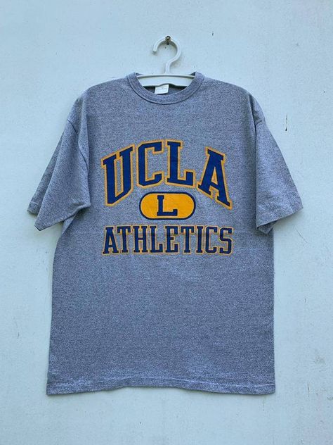 Check out this item in my Etsy shop https://www.etsy.com/listing/1260840360/vintage-80s-ucla-athletics-university-of Ucla T Shirt, University Tees Design, Athletic Department Shirt, College Graphic Tee, University Shirt Design, College Tshirt Designs, Vintage Hoodies Aesthetic, Ucla Shirt, Vintage College Shirts