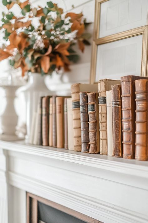 Mantle With Books, Fall Mantle Decor 2024, Lights On Mantle, Books On Mantle, Fall Mantle Ideas, Bedroom Mantle, Moody Cottage, Autumn Mantle, Neutral Fall Decor Ideas