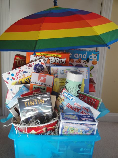 The "Rainy Day" Basket - 2012 - You won’t let a rainy day get you down with this basket of indoor activities!  Books, crafts, games, popcorn and “Adventures of Tin Tin” will help you pass the time at home.  You can even venture out to visit the Ecotarium or the Museum of Science.  This basket certainly won’t give you the rainy day blues. Rainy Day Raffle Basket, Rainy Day Basket Auction, Adventure Basket Gift Ideas, Rainy Day Auction Basket Ideas, Rainy Day Gift Basket, Rainy Day Basket, Silent Auction Gift Basket Ideas, Silent Auction Basket, Basket Raffle