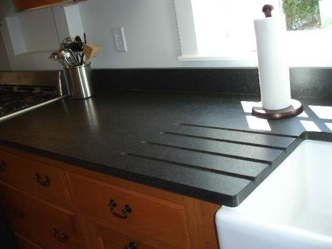 Let NewGraniteMarble.com complete your next countertop project! Black Cambrian granite in leather finish with integrated drainboard over apron sink Uba Tuba Granite Countertops, Honed Black Granite, Uba Tuba Granite, Black Pearl Granite, Slate Countertop, Kitchen Slab, Kitchen Countertops Laminate, Leather Granite, Black Granite Countertops