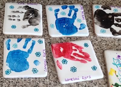 how to make hand print tile coasters                                                                                                                                                                                 More Painting Tiles For Coasters, Painting On Tiles Ceramics Diy Coasters, Painting Ceramic Tiles Crafts, Painting On Ceramic Tiles, Tile Bench, Diy Tile Coasters, Tile Art Projects, Ceramic Tile Crafts, Home Decor Printables