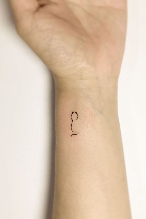 Small Minimalist Tattoo Design For Wrist #wristtattoo #cattattoo Tattoos For Women 2024, 31 Small Tattoos With Big Meanings, Cat Wrist Tattoos For Women, Tiny Cat Tattoos For Women, Cat Tattoo Wrist, Cat Tattoo Leg, Mimalistic Tattoo, Minimalist Tattoo Ideas Women, Minimalist Tattoo Ideas Creative