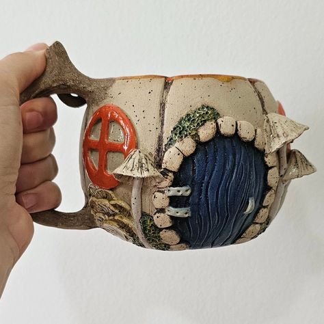 Fantastic Pumpkin Mug, Fairy Door, Hobbit House Mug, Handmade Stoneware Fantastic Mug, Mystical Gifts, One of a Kind Gift #pumpkinmug #pumpkinhouse #pumpkingift #fairydoor #hobbithousemug #hobbithouse #handmadestonewareceramics #uniquegift #ceramicbeermug #ceramicmug #fairyhouse #cottagecore #cottagecoremug #fairymug #mushroommug #hobbitmug #handmadecoffeemug #fairyhousemug Pumpkin House, Pumpkin Gift, Hobbit Hole, Handmade Ceramics Pottery, Hobbit House, Stoneware Ceramics, Fairy House, Art Portfolio, Clay Projects