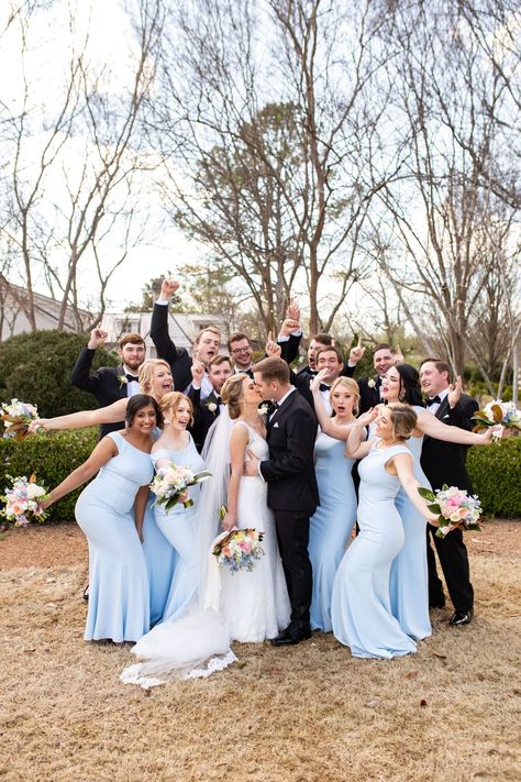 Brilliant pastel-colored bouquets looked stunning against this bridal party's beautiful blue dresses! A perfect look for the whimsical garden wedding 🌈 Bridesmaid And Groomsmen Outfits, Blue Bridesmaid Dresses Mismatched With Groomsmen, Bridesmaid Bouquet Colorful, Beautiful Blue Dresses, Bright Blue Wedding, Pastel Wedding Party, Pastel Colour Bridesmaid Dresses, Elegant Spring Wedding Ideas, Pastel Bridal Party