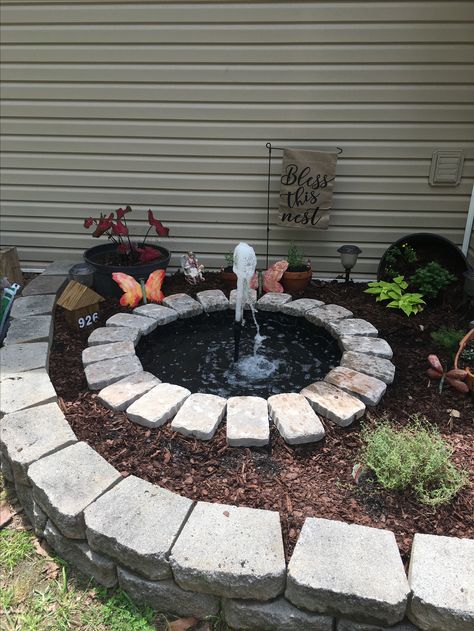 Week end project completed with a $7.00 swimming pool. Small Pond In Backyard, Flower Bed Pond Ideas, Diy Patio Fountain, Kiddie Pool Fountain, Diy Pond Pool, Small Front Yard Pond Water Garden, Kiddie Pool Pond, Pond In Flower Bed, Kiddie Pool Garden