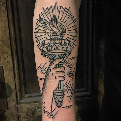 @eastrivertattoo #liberty #torch #statueofliberty #tattoo Liberty Torch Tattoo, Fourth Of July Tattoo, Traditional Tattoo Torch, Hand Holding Torch, July Tattoo Ideas, Torch Tattoo, Holding Torch, Statue Of Liberty Torch, July Tattoo