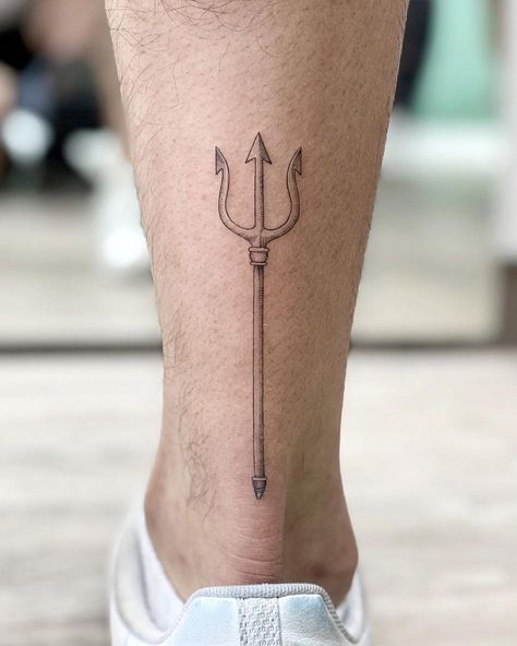 Small trident tattooed on the left calf by @soychapa Calf Tattoo Men Minimalist, Mens Trident Tattoo, Trident Leg Tattoo, Feminine Trident Tattoo, Mens Calf Tattoos Ideas Simple, Minimalist Trident Tattoo, Trident Forearm Tattoo, Greek Trident Tattoo, Small Poseidon Tattoo