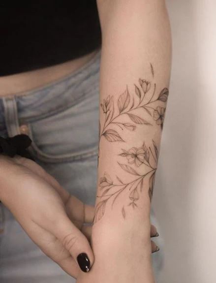 Leaf Tattoo Meaning With 50+ Tattoo Images For Inspiration Leaf Wrap Around Tattoo Arm, Leaf Tattoo Meaning, Floral Wrap Around Tattoo Forearm, Oak Leaf Tattoos, Dogwood Tattoo, Olive Tattoo, Boho Tattoo, 50 Tattoo, Around Arm Tattoo