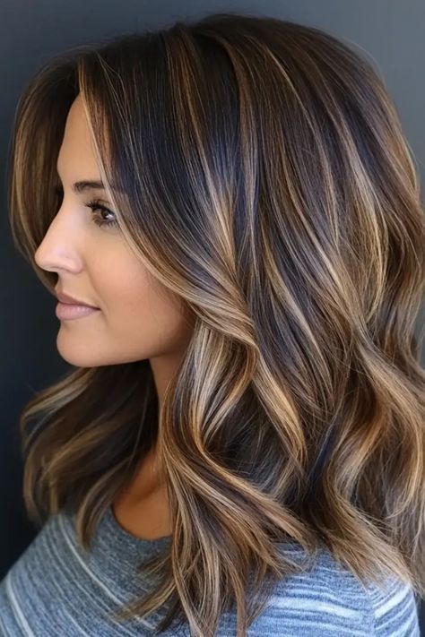 Woman with shoulder-length, wavy hair featuring caramel highlights. Hair Color Framing Face, Smudge Root Highlights, Highlights On Brown Hair Medium Length, Medium Length Dimensional Brunette, Caramel Beige Highlights, Highlight For Brunettes, Brown Hair With Highlights Winter, Brown With Minimal Highlights, Go Back To Natural Hair Color