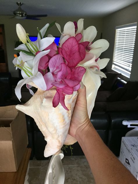 Side view of bridesmaids conch shell bouquet Coral Bouquet, Wedding Reception At Home, Boutonniere Ideas, Shell Bouquet, Beach Bouquet, Aquarium Wedding, Beach Wedding Reception, Succulent Bouquet, Cruise Wedding