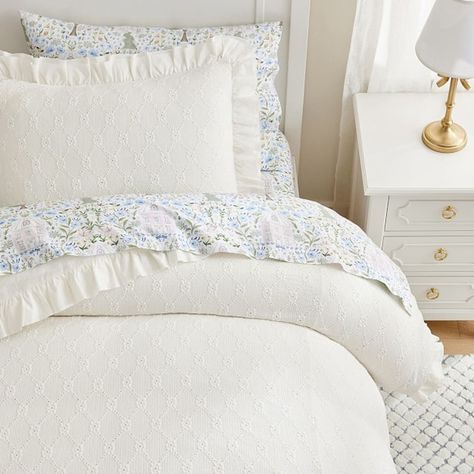 Add dreamy detail to their sleep space with our Nina duvet cover and shams. Embellished with a softly textured trellis and edged in satin ruffles, they come in versatile solid colors that layer beautifully with their favorite sheeting. DETAILS THAT MATTER Made of 99% polyester and 1% spandex dobby weave. Duvet reverses to a 100% cotton design. Twin size duvet is finished with 4 corner ties and 6 buttons to keep duvet in place. Full/Queen duvet is finished with 4 corner ties 8 buttons to keep duvet in place. Shams features an envelope closure. OEKO-TEX(R) STANDARD 100: tested for 1000+ harmful substances to keep you and your family safe. 21.HUS.86232 HOHENSTEIN HTTI. By choosing our cotton products, you're supporting our investment in Better Cotton's mission. This product is sourced via mas Girly Bedding, Preppy Bedroom Decor, Ruffle Duvet Cover, Kids Duvet, Kids Duvet Cover, College Apartment Decor, College Room, White Duvet Covers, Girly Room