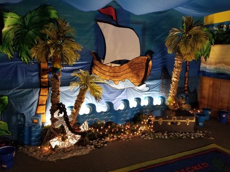 Shipwrecked vbs Treasure Decorations, Ootd Yearbook, Beach Theme Vbs, Pirate Ship Stage Set, Shipwreck Vbs Decorations, Pirate Ship Cubicle, Pirate Scenery Set Design, Kids Church Stage, Shipwreck Vbs