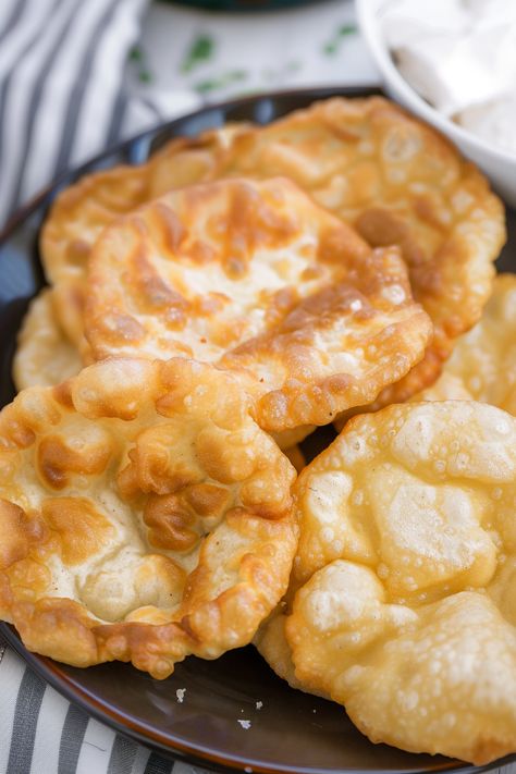 Fry Bread holds a cherished spot in American culinary traditions. It can be enjoyed in savory dishes like Navajo Tacos or sweetened with honey butter and powdered sugar. This easy-to-make bread is perfect for both savory snacks and sweet treats. Unlike typical breads, there's no need to knead the dough extensively. Indian Fry Bread is Indian Fry Bread Recipe Easy, Indian Taco Recipes, Easy Fry Bread Recipe, Indian Fried Bread Recipe, Fry Bread Tacos, Easy Indian Snacks, Indian Fry Bread, Indian Bread Recipes, Fried Bread Recipe