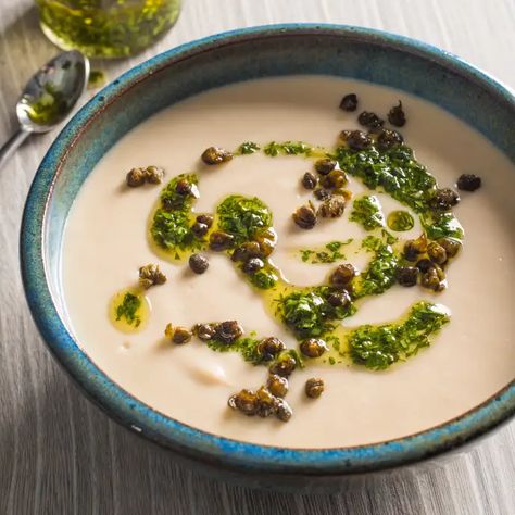 Creamy White Bean Soup with Herb Oil and Crispy Capers | Cook's Illustrated Aperitivo Party, Creamy White Bean Soup, Crispy Capers, Cooks Illustrated Recipes, Herb Oil, Donut Toppings, Cookie Toppings, Plant Based Cookbook, America's Test Kitchen Recipes