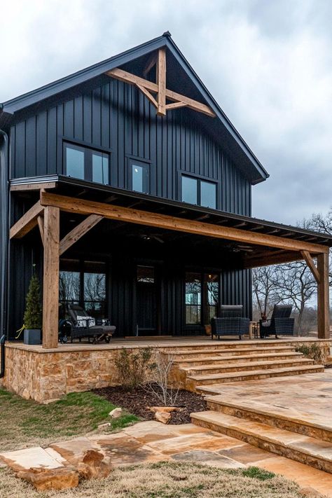 Modern barndominium house black shiplap exterior with dark wood beams. Check out the coolest dark barndominium houses that combine rustic charm with modern sophistication, enhancing a living space with bold hues and sleek designs. Black Barndominium With Wood Accents, Barndominium Siding Ideas, Dark Barndominium Exterior, Dark Barndominium, Dark Modern Farmhouse Exterior, Shiplap Exterior, Black Barndominium Exterior, Barndominium Houses, Barndominium Exterior