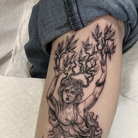 Eddy on Instagram: "Daphne turning into a Laurel tree, inspired by Greek mythology, for Emma. Last one during my visit to @mainlinetattoo 🍃 For bookings and info please click on the link in my bio, and be sure to turn on notifications for booking updates. [Image Description: a fine line, black and grey etching style tattoo of the Nymph Daphne from Greek mythology, turning into a laurel tree, positioned on the outside of the left calf. Daphne is pictured standing on a tree stump with her limbs slowly merging into it with a wreath of flowers below. She’s draped in flowing cloth tied at her waist and her long hair flows down her back. Her arms are lifted up and turning into branches covered in laurel leaves, these also grow from her hair. She has a frightened but determined expression on he Daphne Laurel Tree Tattoo, Daphne Greek Mythology Tattoo, Laurel Tree Tattoo, Daphne Greek Mythology, Laurel Leaves Tattoo, Etching Style Tattoo, Nymph Tattoo, Greek Leaves Tattoo, Laurel Tattoo