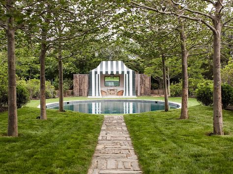 Ethereal garden boasts a round in ground pool placed before a striped pool house filled with wicker chairs and a faux bois mirror. David Netto, Pool With Pool House, Oval Pool, Fire Pit Landscaping, Round Pool, Asian Garden, Modern Backyard, Beautiful Pools, Garden Pathway