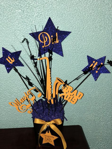 Saxophone graduation Centerpiece. Saxophone Centerpieces, Silhouette Head, Star Centerpieces, Graduation Centerpiece, Boy Silhouette, Graduation Tables, Saxophone Players, Grad Caps, Music Instrument