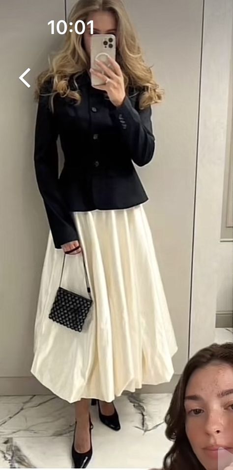 Blonde girl in her 20s taking a mirror selfie of her outfit, she is wearing a long off-white skirt and a black cardigan. She is small black heels and carries a small crossbody bag wrapped around her left hand. Her hair is styled with a blow out and she has big puffy wavy curls. Fall Cotton Skirt In Beige, Balloon Skirt Outfit 2023, Skirt And Baggy Sweater, White Balloon Skirt Outfit, Oversized Cardigan With Skirt, Balloon Outfit, Balloon Skirt, Fall 23, Fall 2023