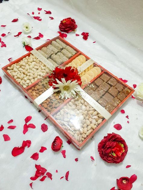 A gift hamper made with rich dry fruits and nuts for engagement, wedding or party events. Link for tray with compartments given below: https://www.amazon.in/MosQuick%C2%AE-Divided-Appetizer-Compartments-Platters/dp/B0C1BY12MS/ref=sr_1_53?crid=2T8XCHVU8T0EW&keywords=tray+with+compartments&qid=1687679616&sprefix=tray+with+compartment%2Caps%2C202&sr=8-53 Dry Fruits Packing Ideas Gift Basket, Nuts Hamper, Dry Fruits Hamper, Engagement Packing Ideas For Bride, Fruits Hamper, Engagement Packing, Arabic Baby Names, Fruit Hampers, Dry Fruit Tray