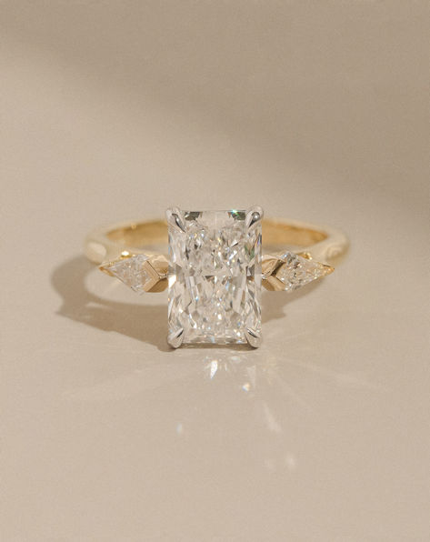 Showcasing a single claw set radiant cut centre stone flanked by kite-shaped diamonds, this is one of the latest bespoke trilogy-style engagement rings to have been crafted in the Hogans workshop.⁠ ⁠ To meet with our Master Jeweller for an obligation-free design consultation. ⁠ R9468 Radiant Cut Trilogy Ring, Radiant Trilogy Ring, 2ct Engagement Ring, Wedding Necessities, Radiant Diamond Rings, Radiant Ring, Trilogy Engagement Ring, Radiant Engagement Rings, Cute Engagement Rings